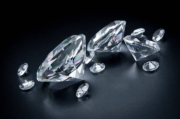 "This is not a 3D render, this is photo. Few, various sizes diamonds scattered on black background. Beautiful, very expensive, precious stones."